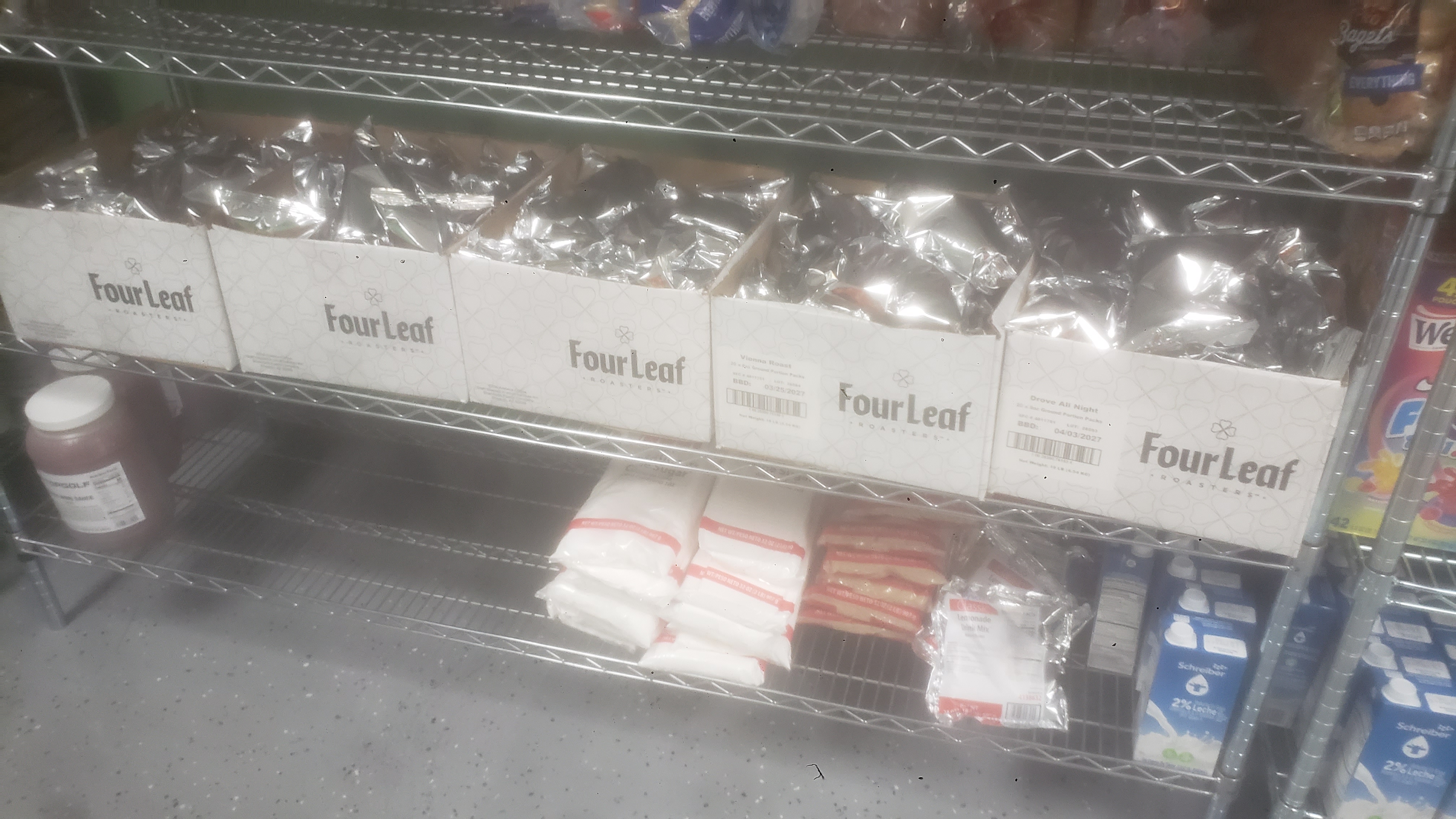 Coffee packets in a cardboard box on a shelf